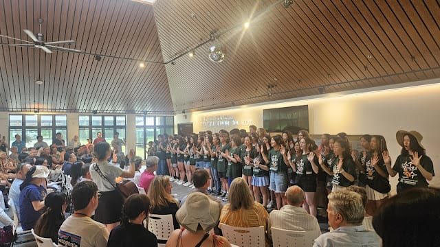 Students are singing in a choir at Korean language village USA.