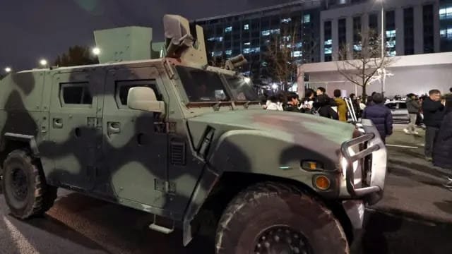 A military armored vehicle stopped in the middle of a city